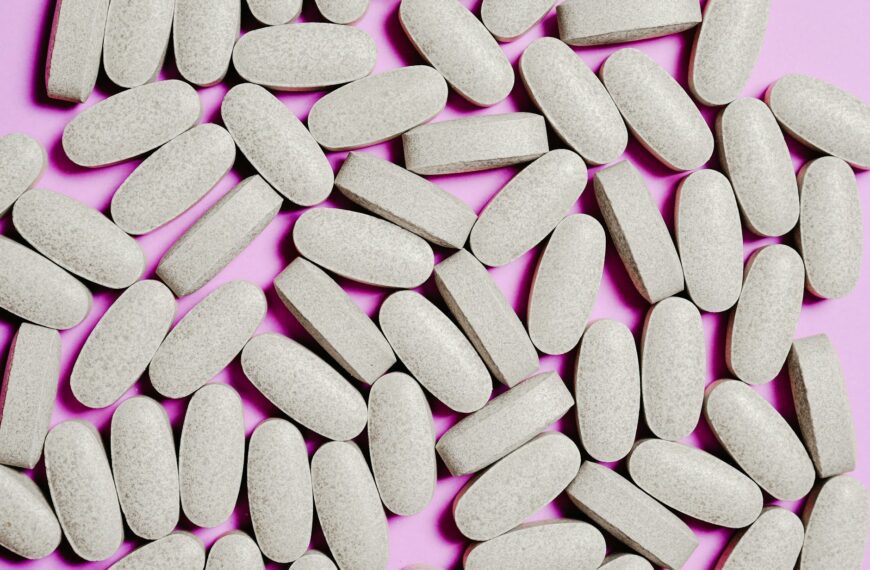 white medication pills isolated on purple background